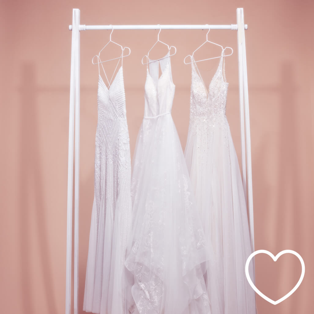 wedding dresses hanging on a dress rack