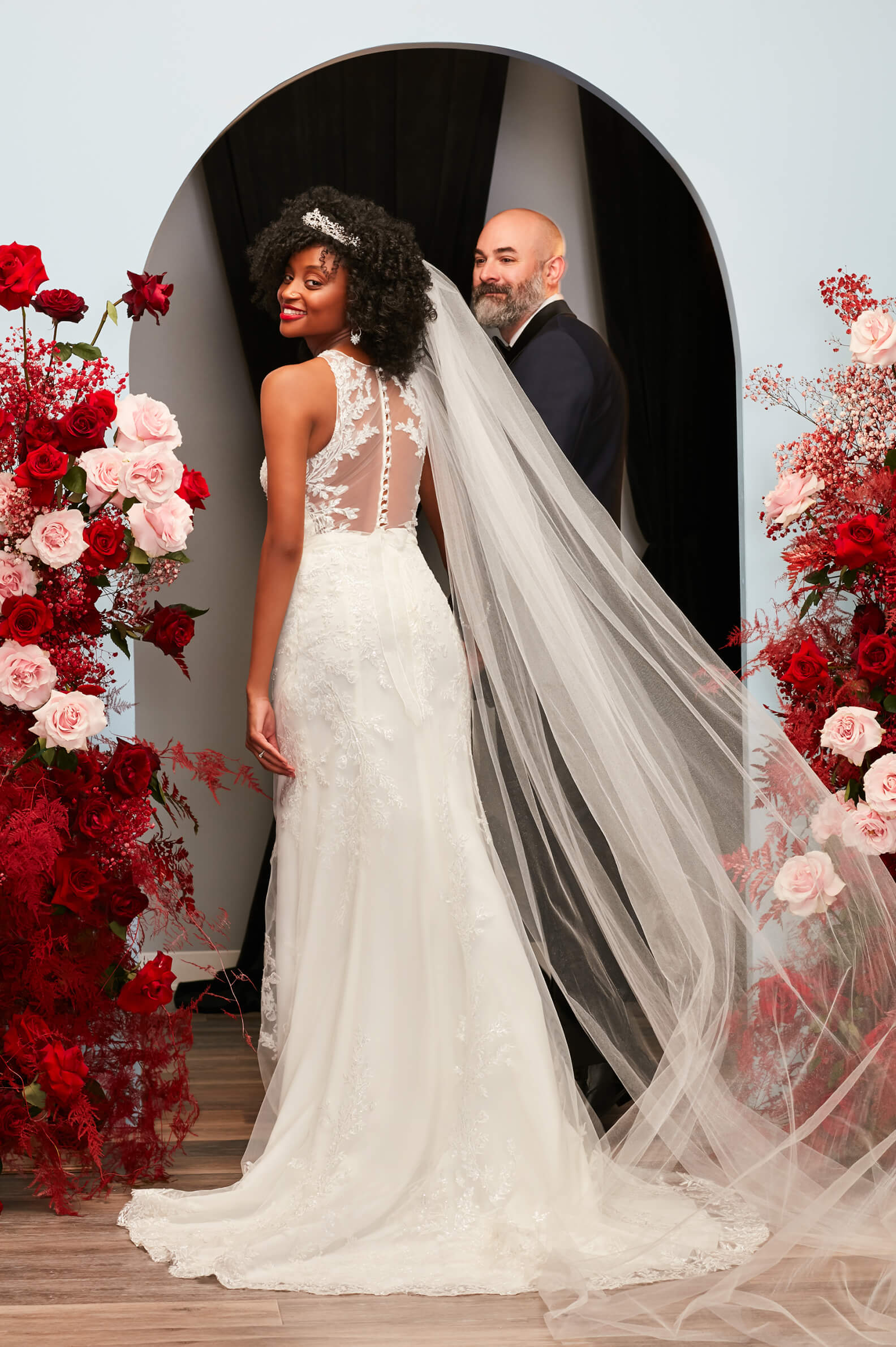 bride and groom holding hands and walking through archway